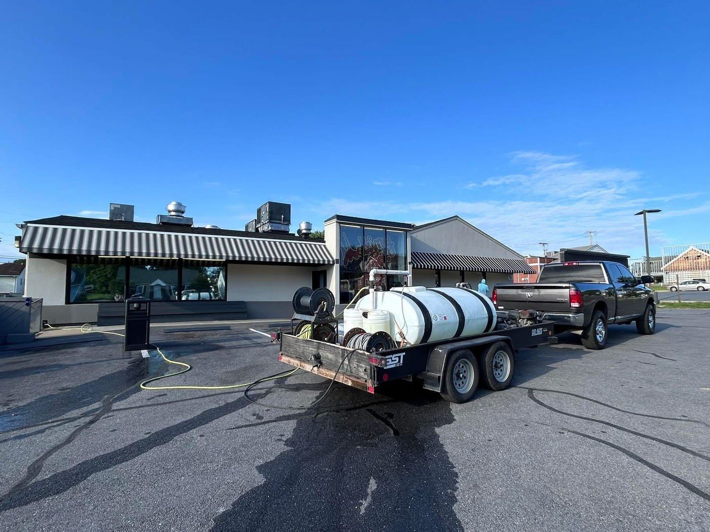 Chem-Clean rig beside a restaurant, the lot wet from washing