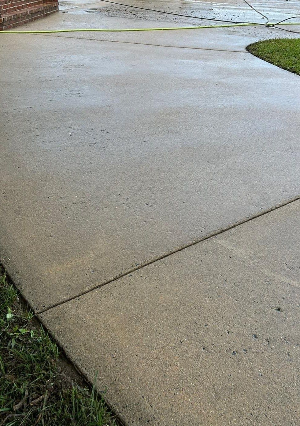 The same driveway edge bright and even after pressure washing