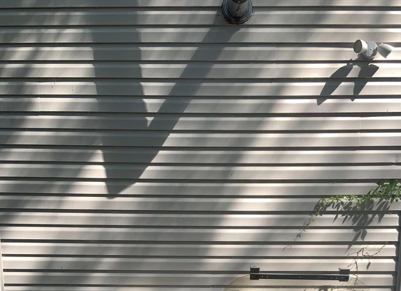 The same vinyl siding under the vent pipe, clean after rust stain removal