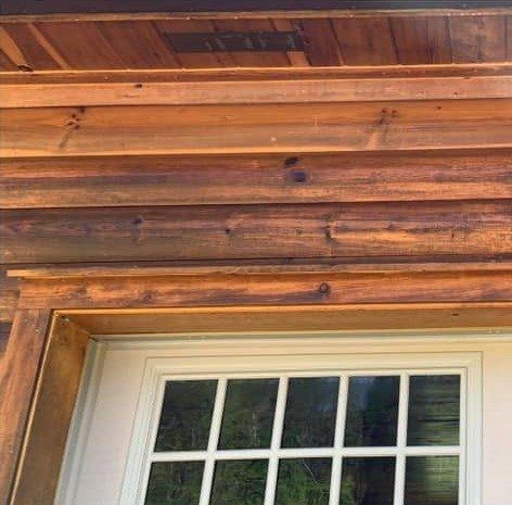The same log siding above the garage door clean after washing