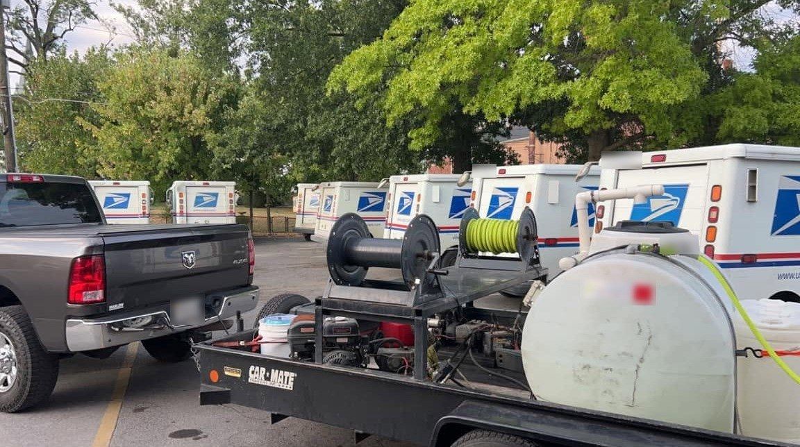 Our trailer wash rig with hose reels and water tank, parked in the Strasburg post office lot