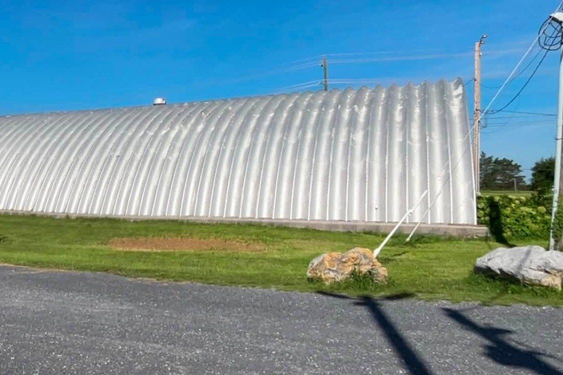 Long curved metal roof shining after a wash