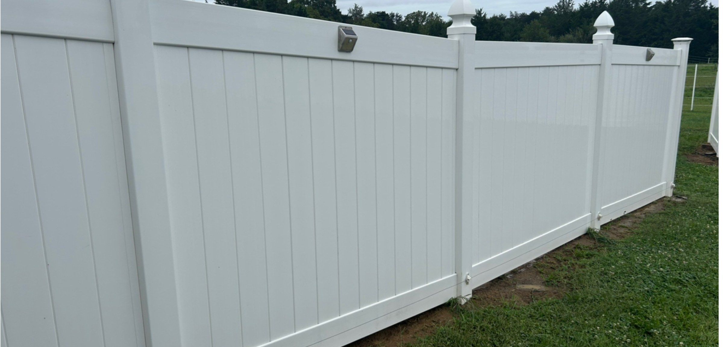 The same fence after washing, clean white panels