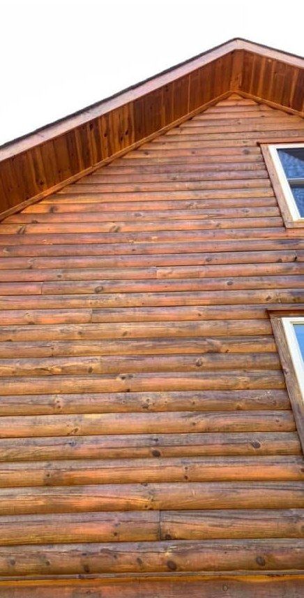 The same log gable after washing, warm natural wood